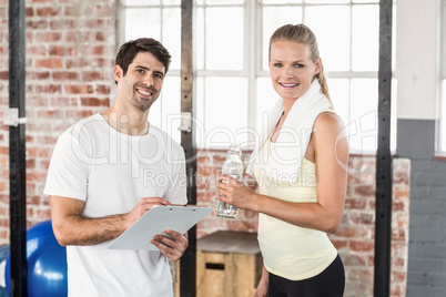 Muscular woman watching her results on clipboard