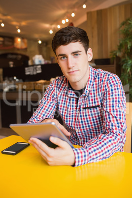 Portrait of young man using digital tablet