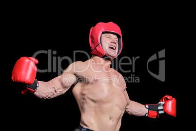 Boxer with arms outstretched against black background