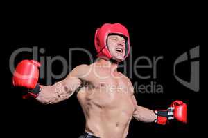 Boxer with arms outstretched against black background
