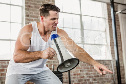 Instructor holding megaphone and pointing