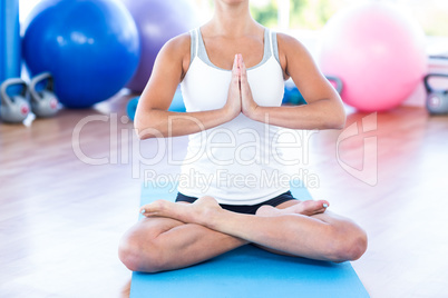 Woman doing lotus posture with hands joined