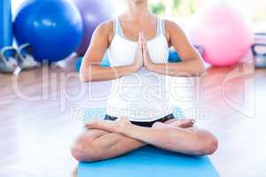 Woman doing lotus posture with hands joined