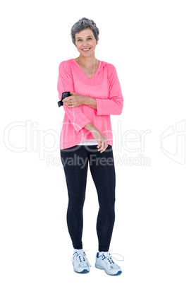 Portrait of happy fit woman wearing armband