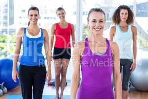 Fit women smiling in fitness studio