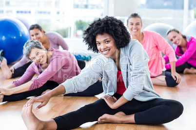 Cheerful fit women touching toes
