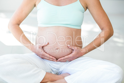 Midsection of woman doing yoga