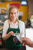 Female worker accepting payment through credit card