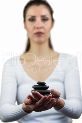 Portrait of woman holding pebbles