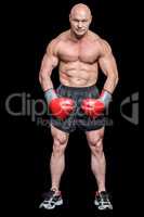 Portrait full length of bald boxer flexing muscles