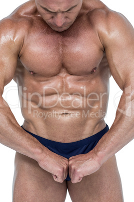 Powerful athlete flexing muscles