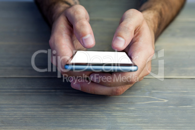 Cropped image of person holding mobile phone