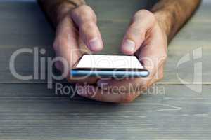 Cropped image of person holding mobile phone