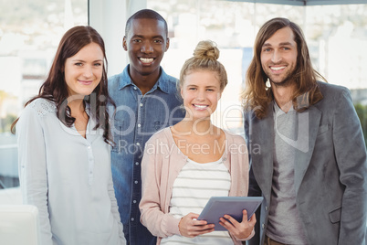 Portrait of smiling business team with woman holding digital tab