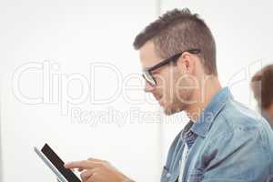 Man with eyeglasses using digital tablet