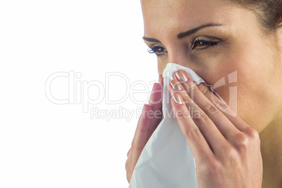 Close-up of sick woman with tissue on mouth