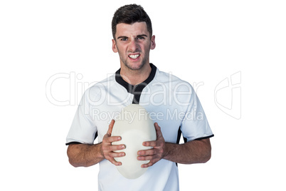 Portrait of an angry rugby player holding ball