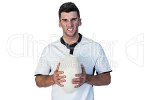 Portrait of an angry rugby player holding ball