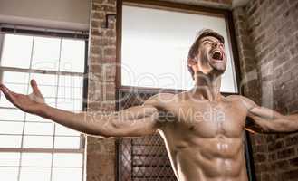 Muscular man with arms stretched
