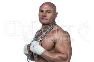 Portrait of confident bodybuilder holding chain