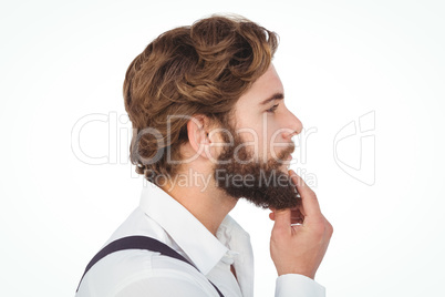 Profile view of hipster touching beard