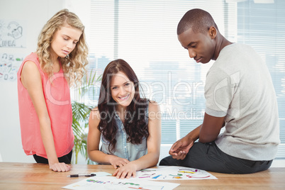 Portrait of smiling woman with business people working at desk Portrait of smiling woman with business people working at desk