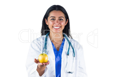 Smiling doctor with an apple in her hand