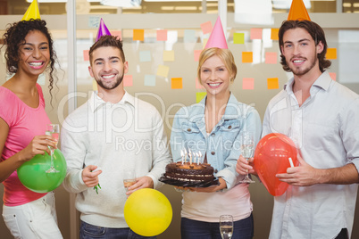 Portrait of colleagues enjoying birthday party