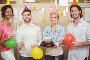 Portrait of colleagues enjoying birthday party