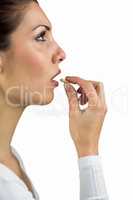 Side view of woman taking pill