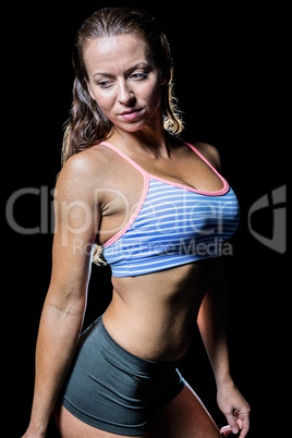 Thoughtful female athlete in sportswear looking away