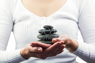 Mid section of woman holding pebbles Mid section of woman holding pebbles