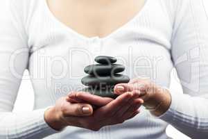 Mid section of woman holding pebbles