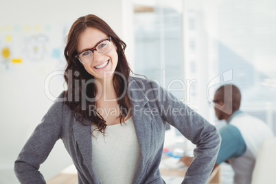 Portrait of smiling businesswoman wearing eyeglasses with hand o
