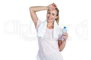 Sporty woman touching forehead while holding bottle