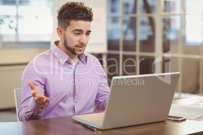 Surprise businessman looking at laptop