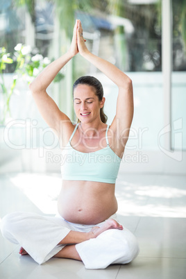 Happy woman meditating on floor