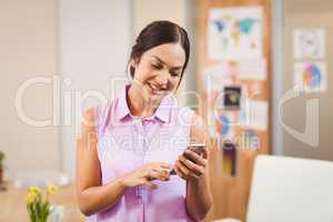 Businesswoman texting on phone