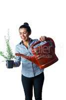 Happy woman watering a plant