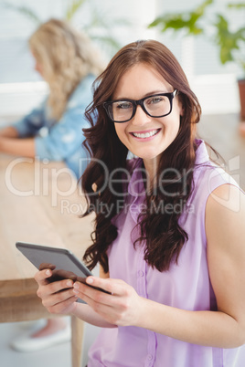 Portrait of smiling woman wearing eyeglasses while holding digit