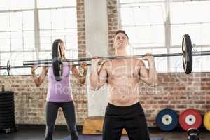 Two fit people working out at crossfit session
