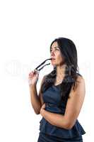 Woman holding her glasses against her lips