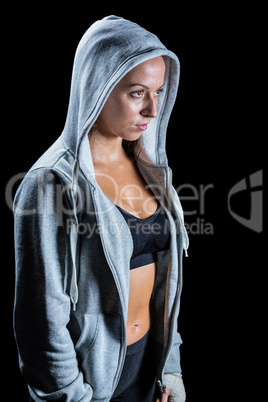 Thoughtful female athlete in hood