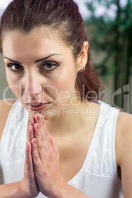 Confident woman with joined hands