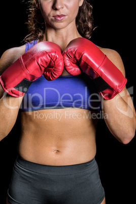 Midsection of female boxer with fighting stance