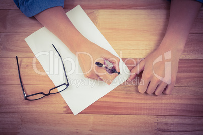 Man writing in paper at desk Man writing in paper at desk