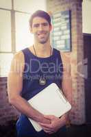 Portrait of a trainer holding clipboard