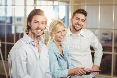 Smiling business people with laptop in office