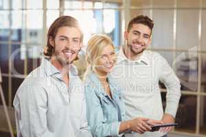 Smiling business people with laptop in office