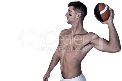 Shirtless rugby player ready to throw the ball